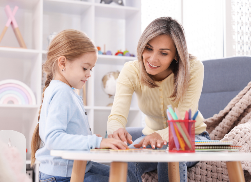 A homeschool mother working through colorful lessons at the table with her child